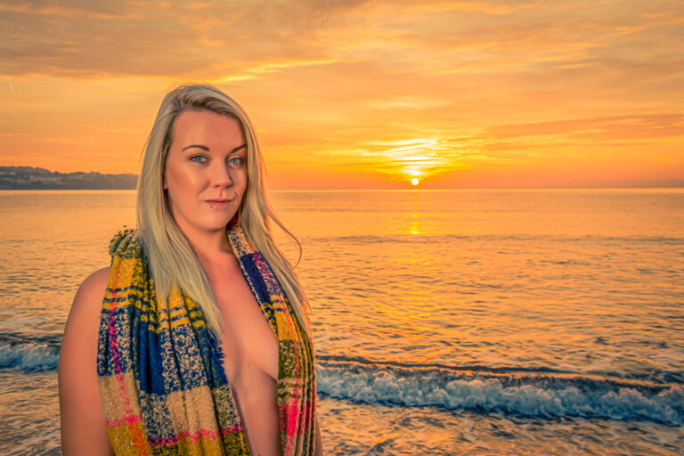 Confidence builder photoshoot in Devon featuring an adult model in an implied nude beach portrait at sunrise