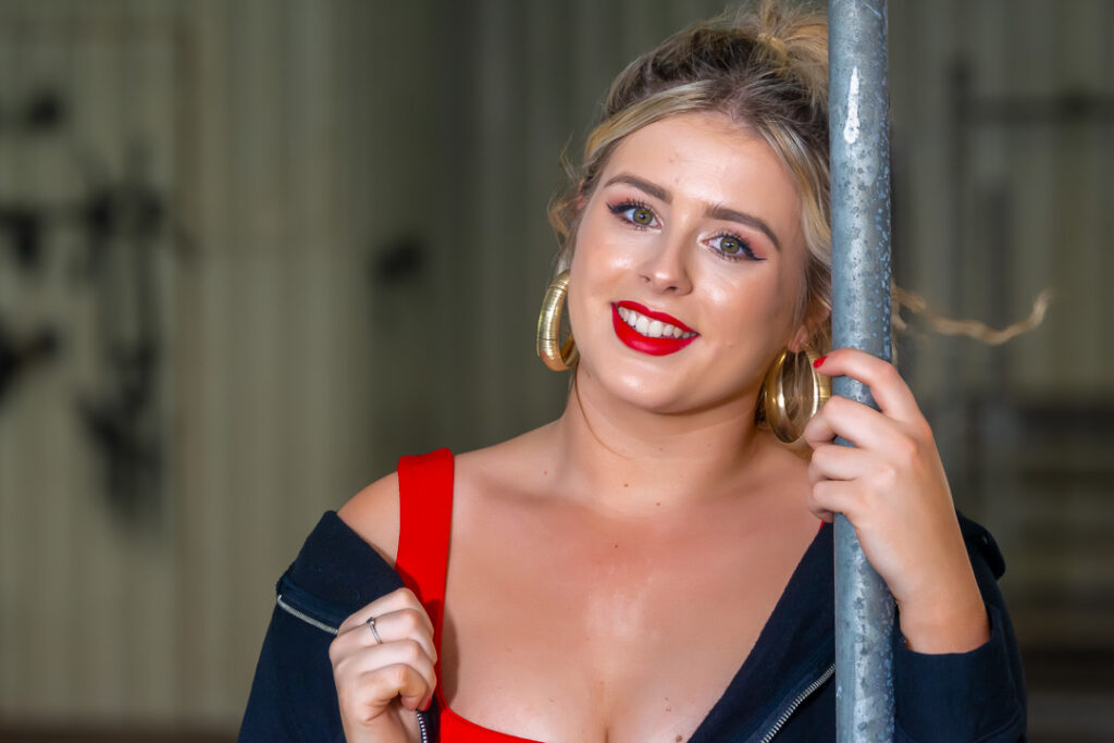 Photoshoots in Devon and Cornwall, farmer girl in a red dress at a cattle market